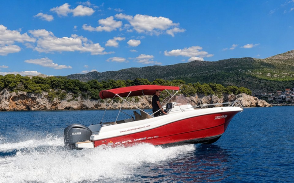 Red speedboat cruising along the Dubrovnik coast
